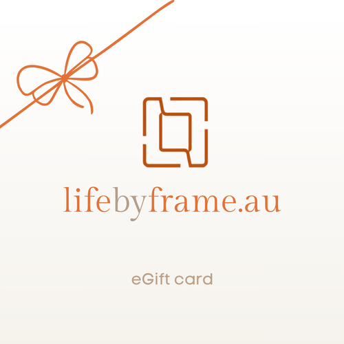 A minimalist eGift card design with an orange gift bow line drawing, a stylized orange square logo, and the text 'lifebyframe.au' and 'eGift card' on a very light warm background.