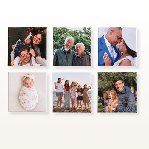 Six square custom photo prints arranged in a 2x3 grid on a light beige wall. The photos depict various family and pet moments, including a newborn swaddled in white, a couple in a blue suit, a group of friends on a beach, and a man holding a brown dog.
