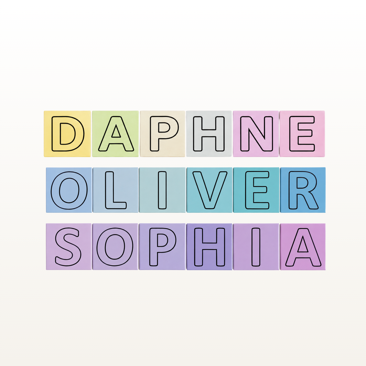 Customizable pastel letter tiles spelling out names, shown with the names 'DAPHNE OLIVER SOPHIA' on a light cream background.