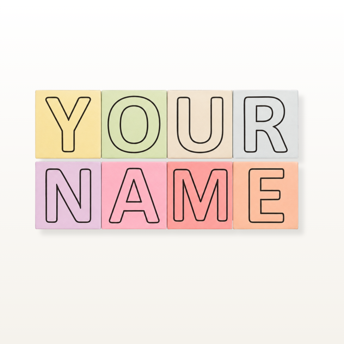 Six pastel-colored square letter tiles arranged in two rows to spell out 'YOUR NAME' in outline letters, set against a light beige background.